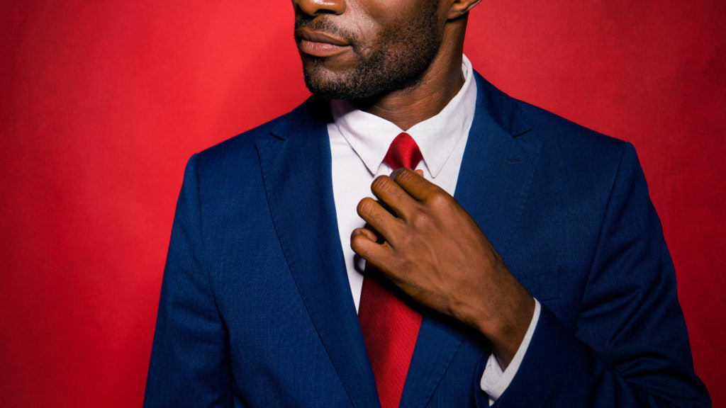 Man with stubble in blue suit