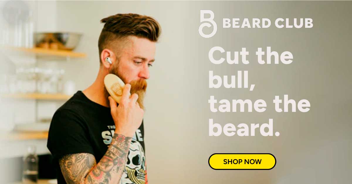 Man brushing his beard