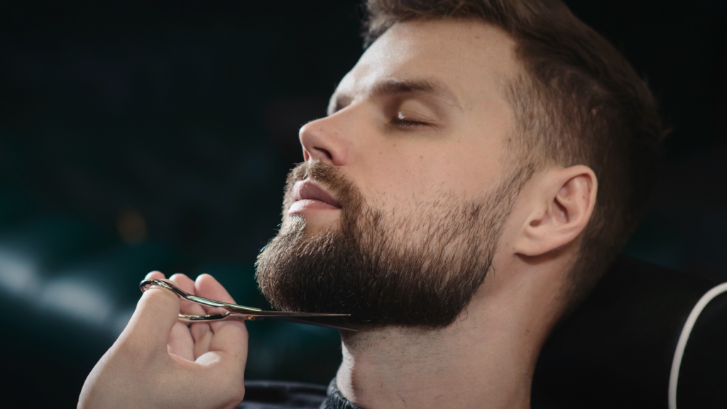 Man getting beard cut with closed eyes